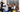 Man in a suit showing factory workers a whiteboard