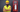 Man in a yellow hard hat standing next to a fire extinguisher
