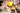 A construction worker holding his hard hat and wearing a tool belt