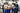 Factory workers shaking the hand of a business woman