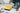 Man rolling a paint roller in yellow paint